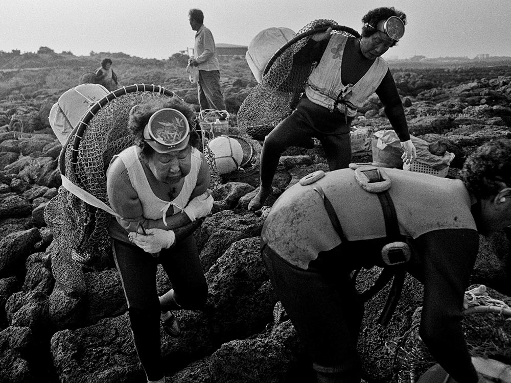 Elder women scuba divers gather their fishing gear